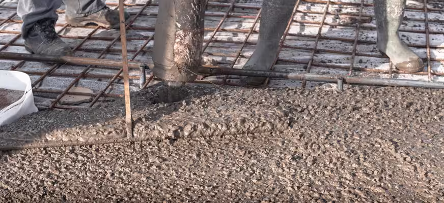 Construction team placing reinforced concrete for structural building elements
